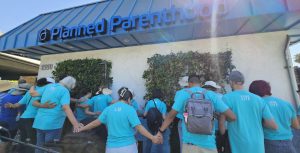 Love Life volunteers praying outside Planned Parenthood