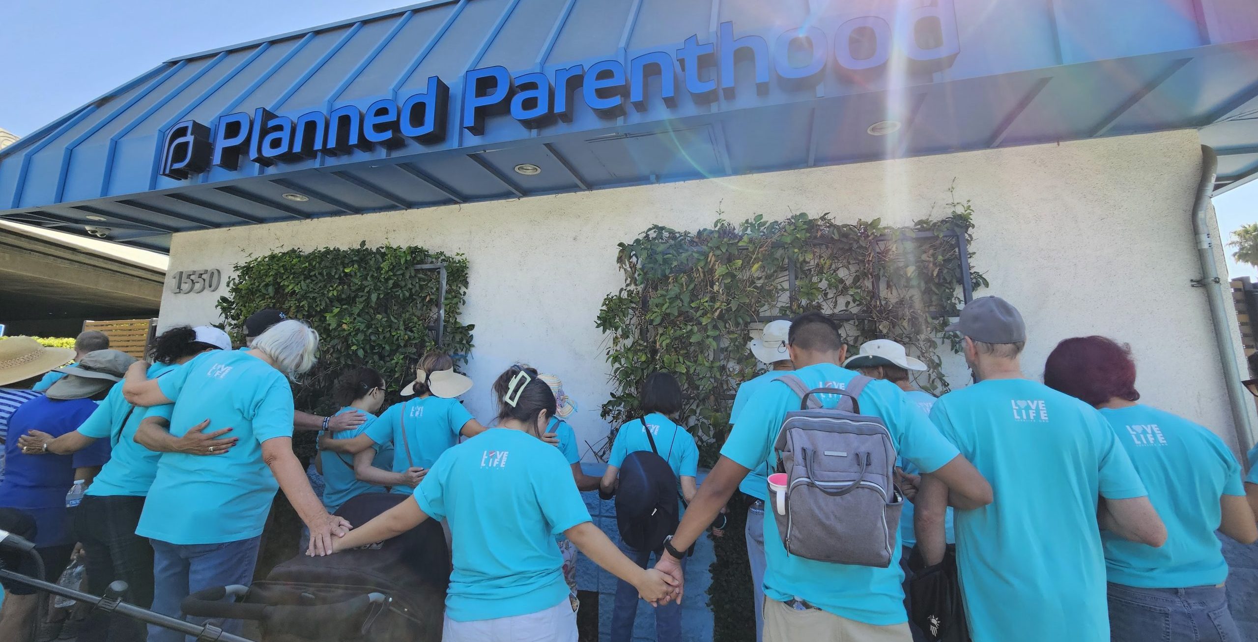 Love Life volunteers praying outside Planned Parenthood